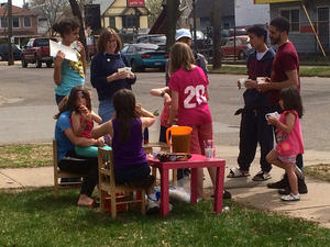 Jane Prince at the lemonade stand with neighborhood girls Photo of people around children's lemonade stand.