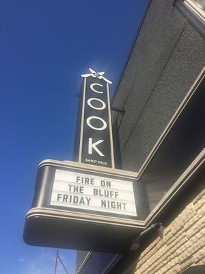 Photo of Cook St. Paul restaurant marquee reading Fire on the Bluff Friday Night.