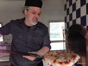 Photo of Barry removing pizza from Airstream oven